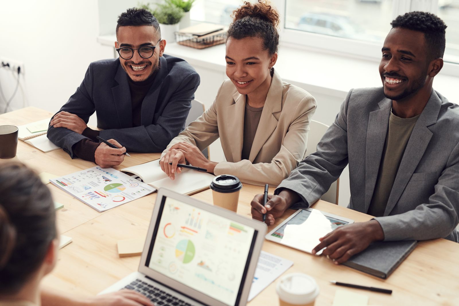 Profissionais sorrindo durante reunião de trabalho